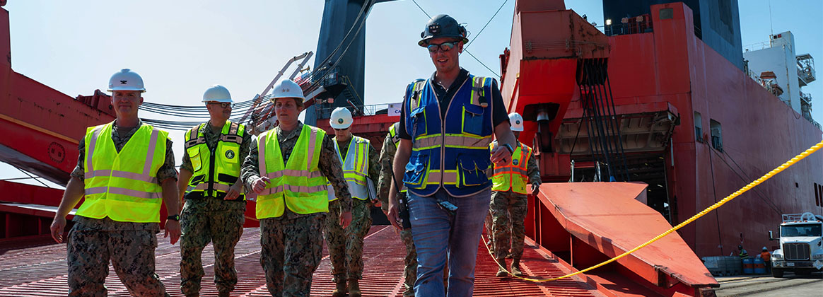 A photo of military personnel disembarking a large ship.